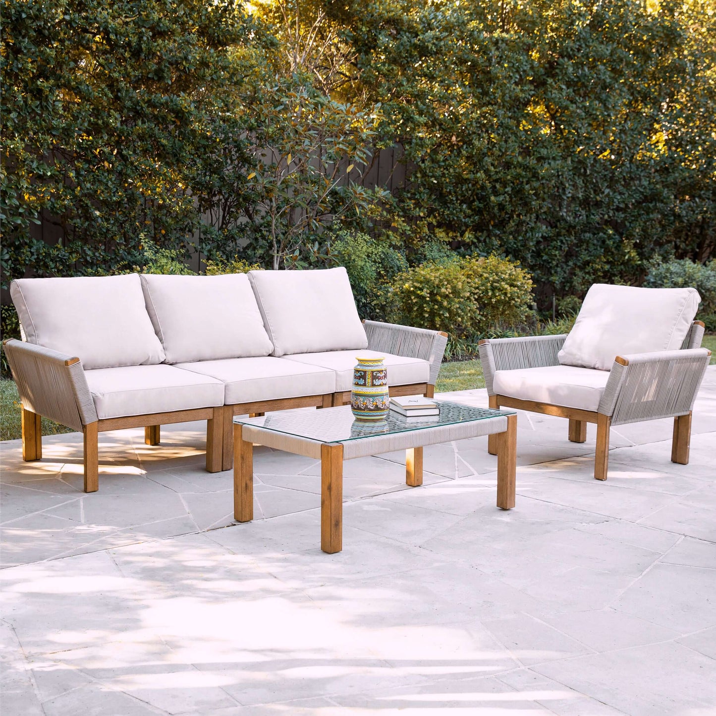 Lifestyle image of Outdoor Glass-Top Coffee Table Brendina in patio