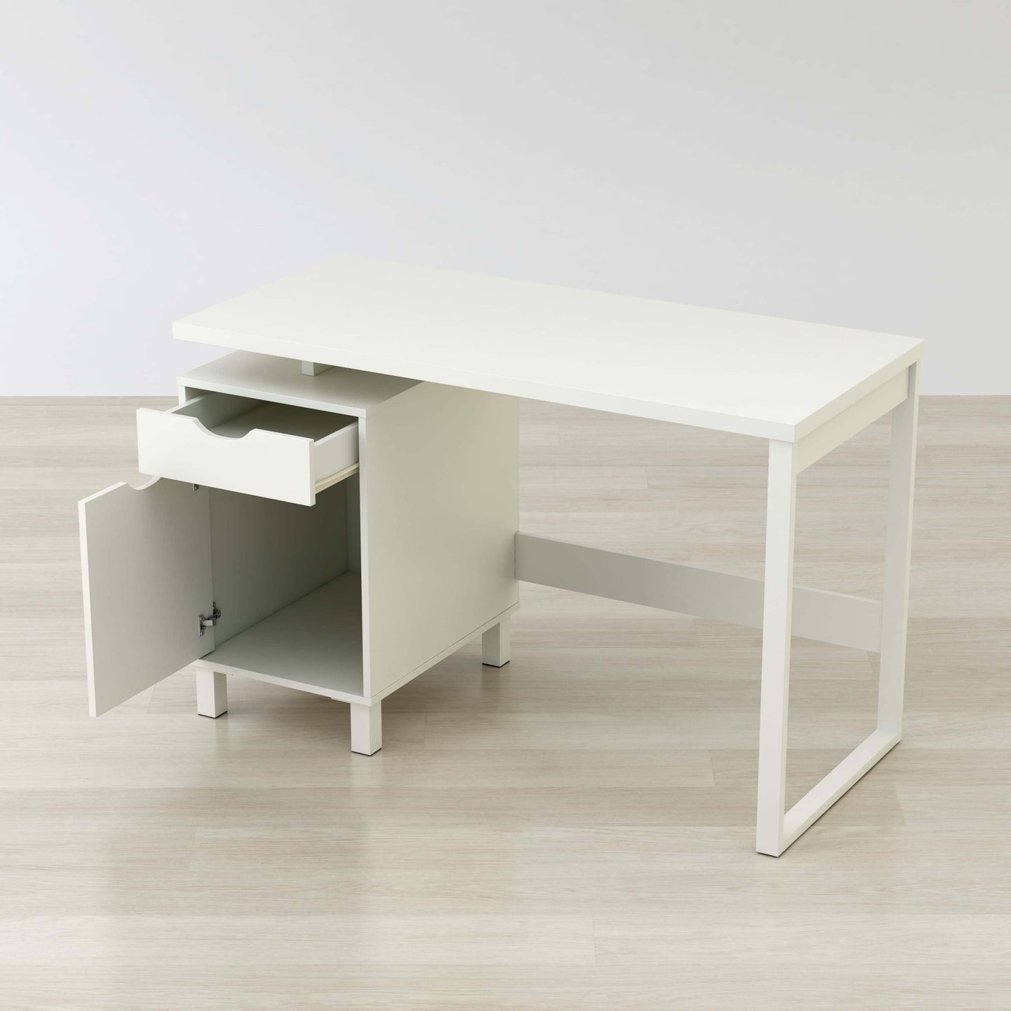 Angled view of compact home office desk with a drawer and storage cabinet 