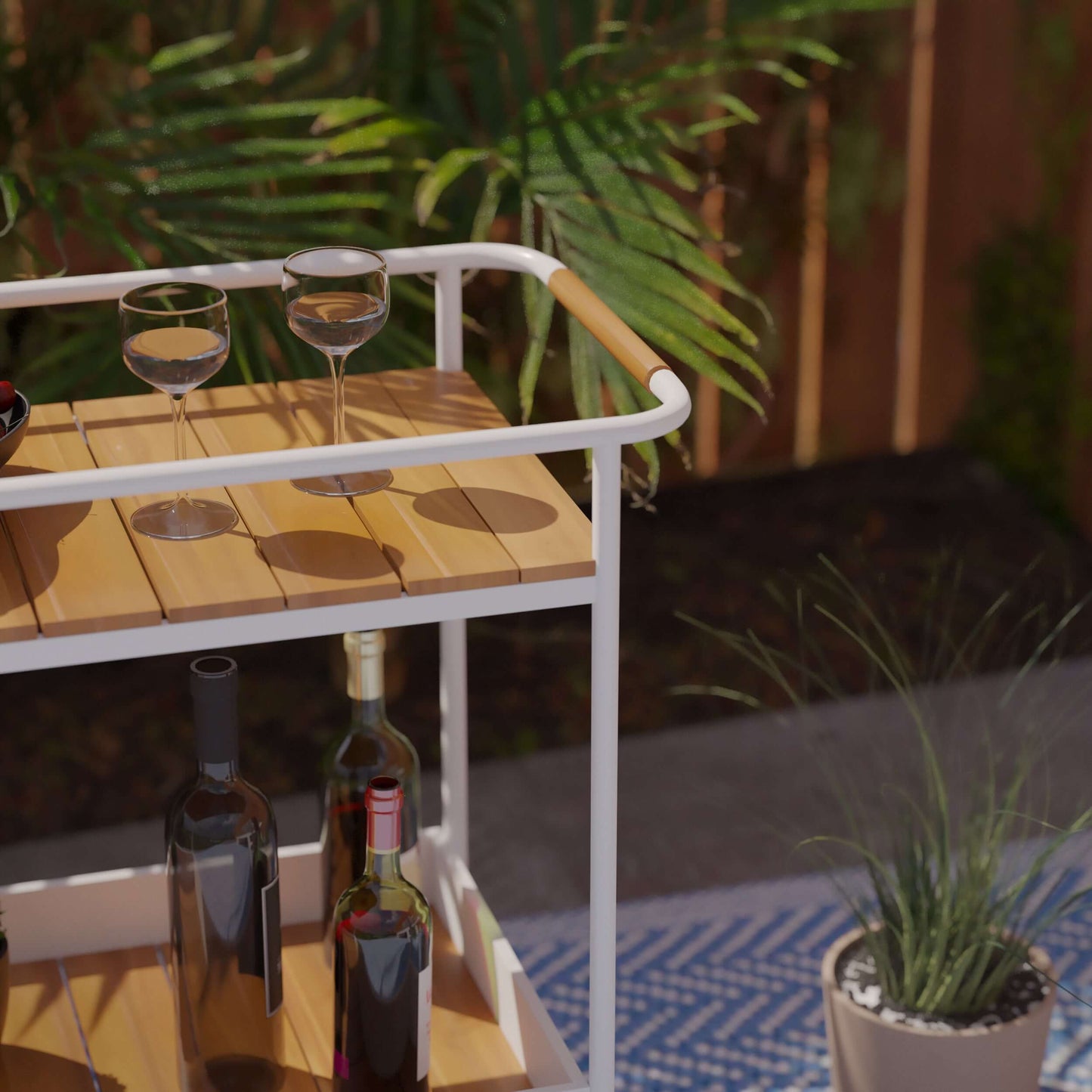 Randburg Outdoor Bar Cart w/ Storage - bar cart close up outside with items on top 