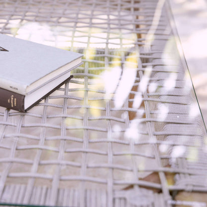 Lifestyle image of Outdoor Glass-Top Coffee Table Brendina with accessories 